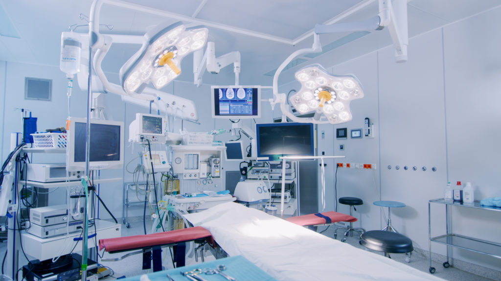 Establishing Shot of Technologically Advanced Operating Room with No People, Ready for Surgery. Real Modern Operating Theater With Working equipment,  Lights and Computers Ready for Surgeons and a Patients.